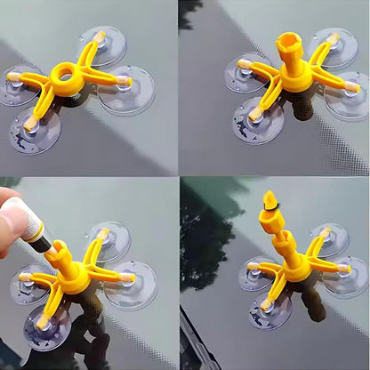 Yellow suction cup tool with multiple suction cups on a gray surface.